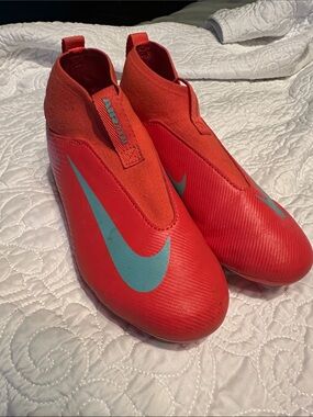 Nike Kids Red Soccer Cleats with Teal Swoosh